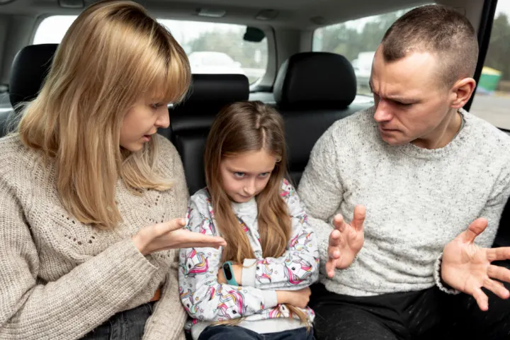 overbearing parents: overbearing mother and controlling dad are berating girl in the backseat of the car - controling parents pscyhology