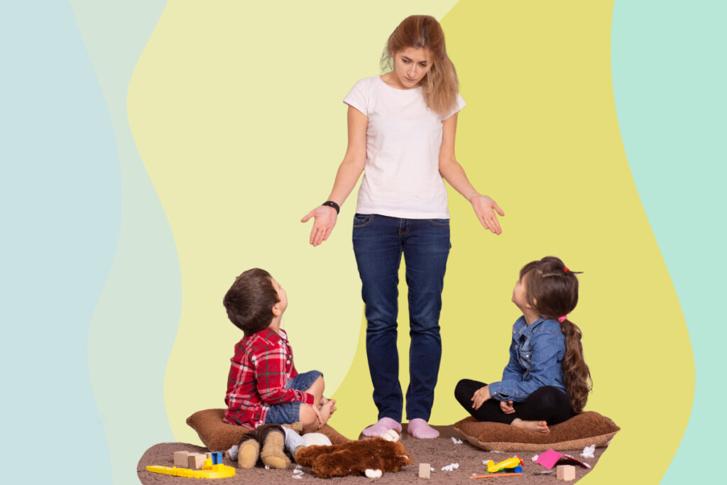 A mother scolds her children making a mess of toys on the floor.