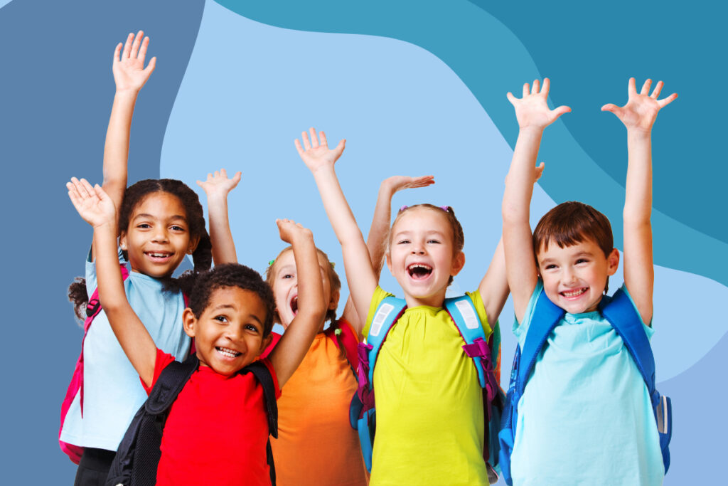 A group of excited preschool kids lifting their arms up and smiling.