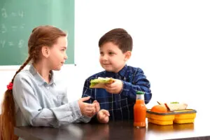 boy gives girl his sandwich