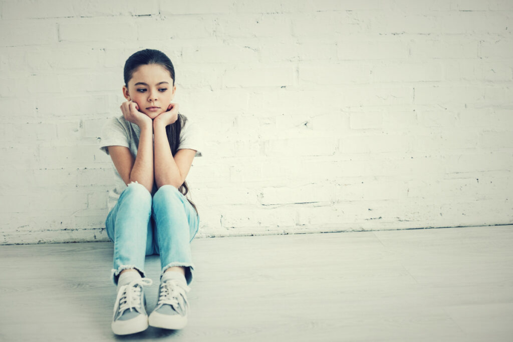 girl sits on ground emotional invalidation examples