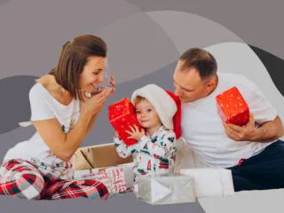 overindulgent parents and toddler surrounded by gifts