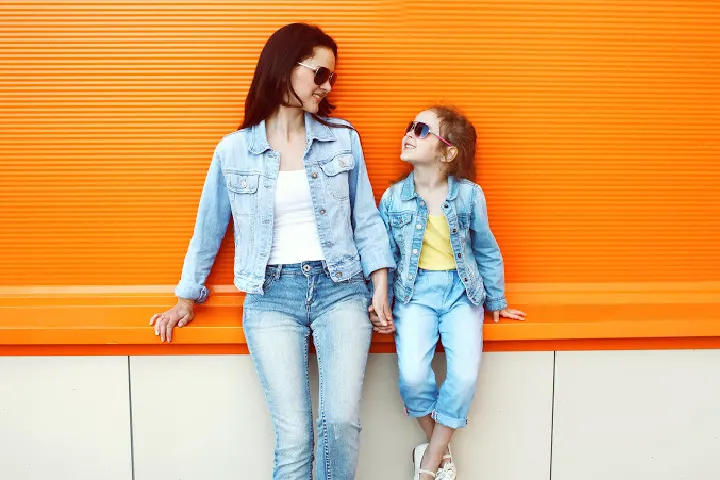 Mother and daughter both wear sunglasses. Mother models how to be a good parent by Improving parenting skills, being a parent