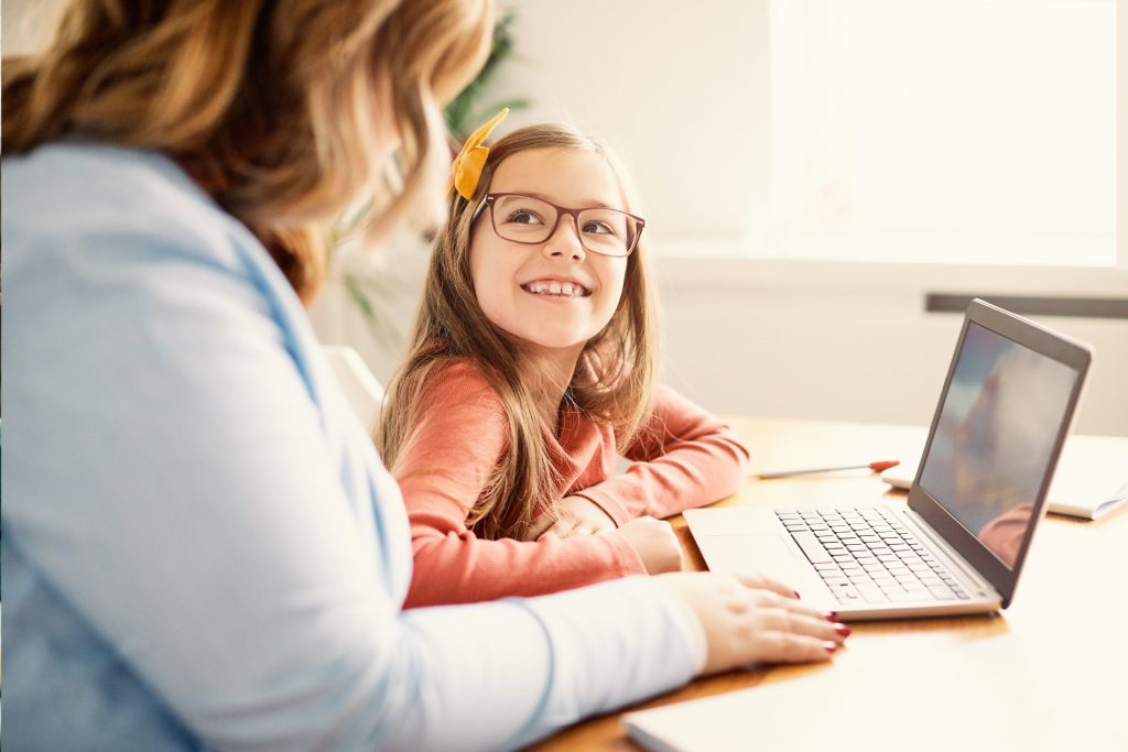 mother daughter study in front of laptop using positive parenting solutions positive oarenting