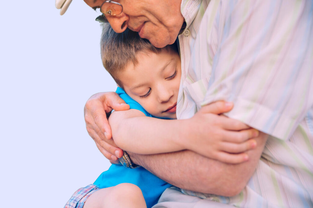 boy hugs grandfather healthy interpersonal relationships