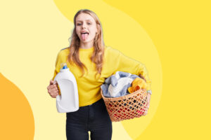 preteen holding laundry and detergent
