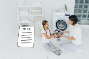 girl does laundry with mom with a to do list