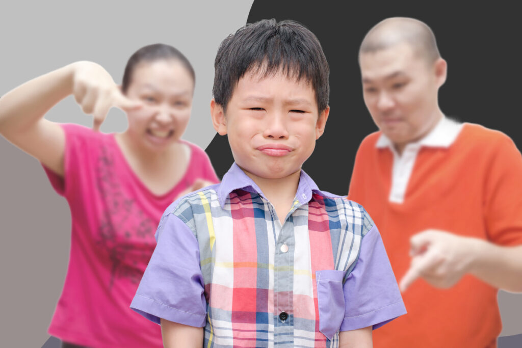 angry parents point to boy who cries